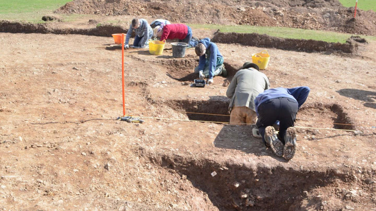 ANU Archaeologist Dr Catherine Frieman & co-director James Lewis with funerary pot in situ. Credit: (c)SEKAS