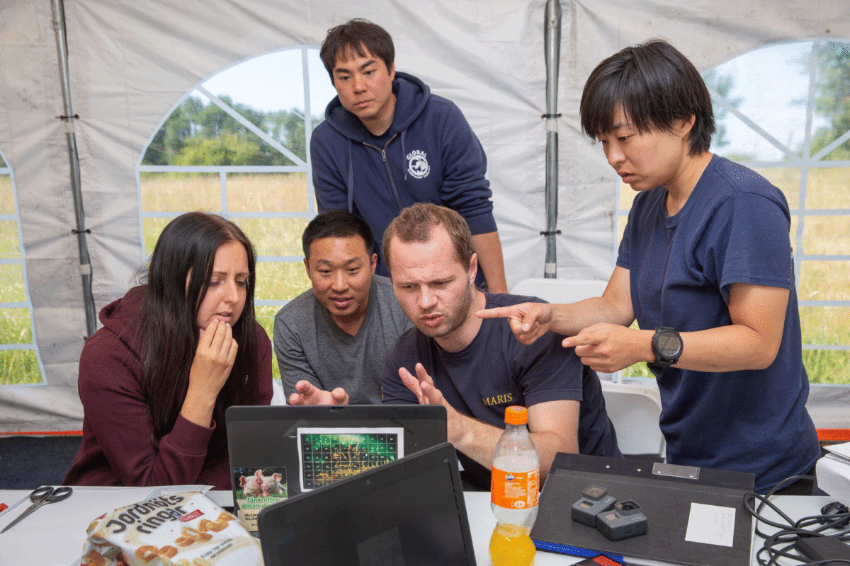 The research team analyse the data with the divers. Photo Credit: Kirill Egorov / Ocean Discovery / Mars Project / Nordic Science.