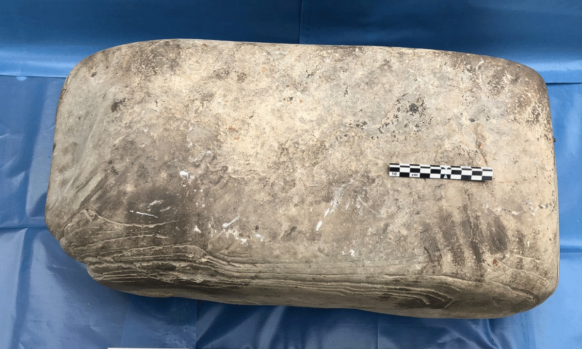 A stone anvil bearing an ancient handprint that has been discovered in a Pictish settlement on the Scottish island of Rousay. Photo Credit: University of Bradford / The Guardian.