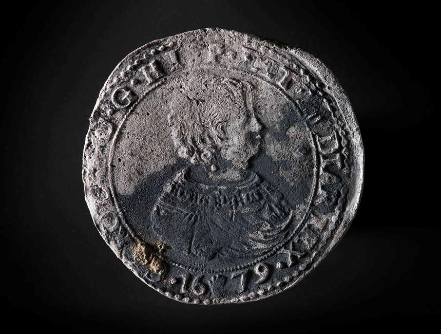 Ducaton from 1679. This side of the ducaton shows the depiction of a Spanish king. The ducaton first made its entrance in the Netherlands in the province of Brabant in 1618, depicting Albert and Isabella. Photo Credit: ©Historic England/RCE.