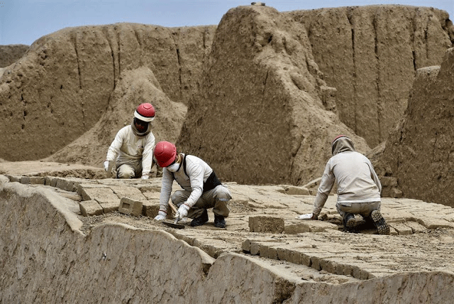 Experts work on the restoration of an ancient structure at the Chan Chan archaeological site, where archaeologists recently 
discovered 20 wooden sculptures, in the outskirts of the northern city of Trujillo, in Peru on October 22, 2018. Photo Credit: AFP / Chris Bouroncle / TANN.