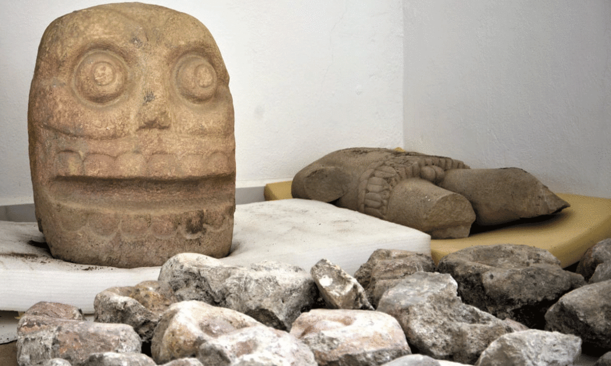 A skull-like stone carving and stone trunk depicting the Flayed lord. Photo Credit: Meliton Tapia Davila/AP/The Guardian.