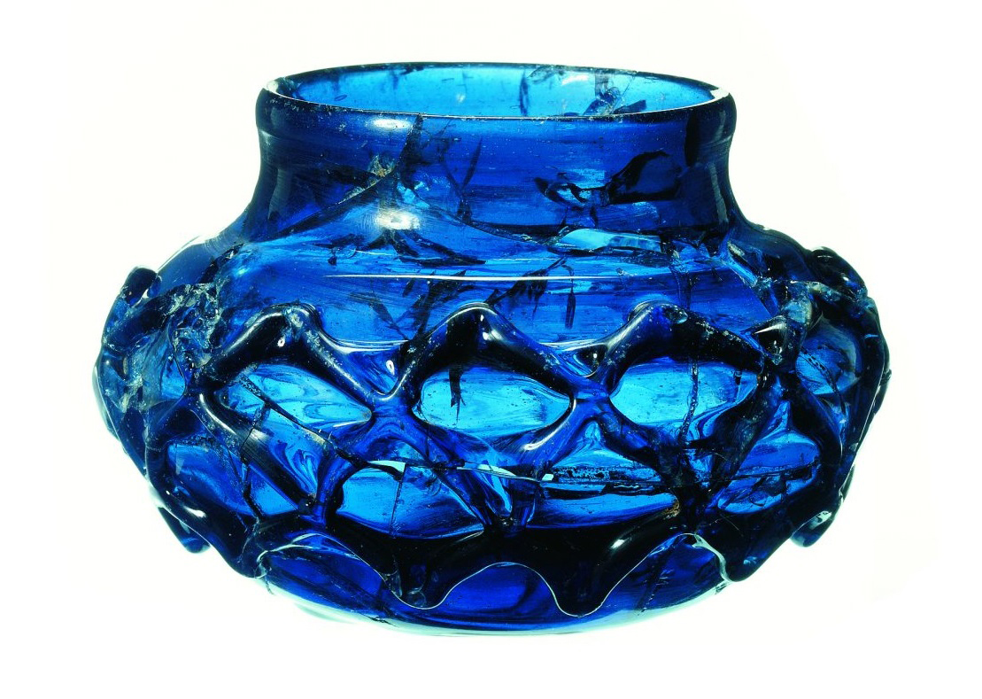 One of two rare blue glass decorated beakers. The two were almost certainly made as a matching pair and discovered in tact within the burial chamber. Credit: MOLA