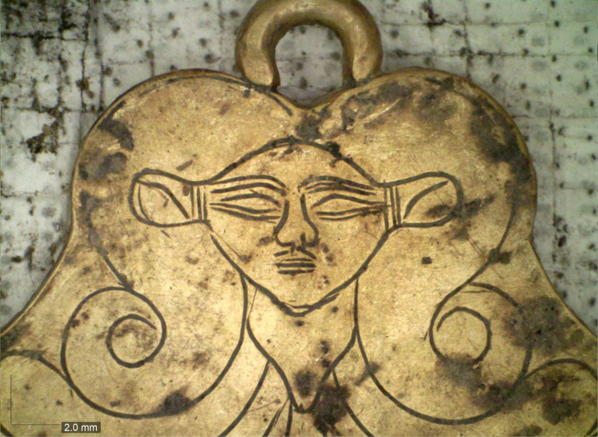 UC archaeologists found a gold pendant in the family tombs at Pylos featuring the likeness of Hathor, an Egyptian goddess who was a protector of the dead. Photo/UC Classics