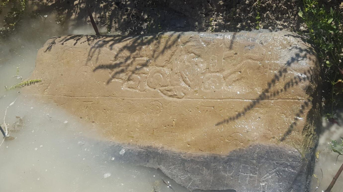 A tip from a local Turkish farmer led archaeologists to this stone half-submerged in an irrigation canal. Inscriptions from the 8th century BC are still visible. Credit: James Osborne