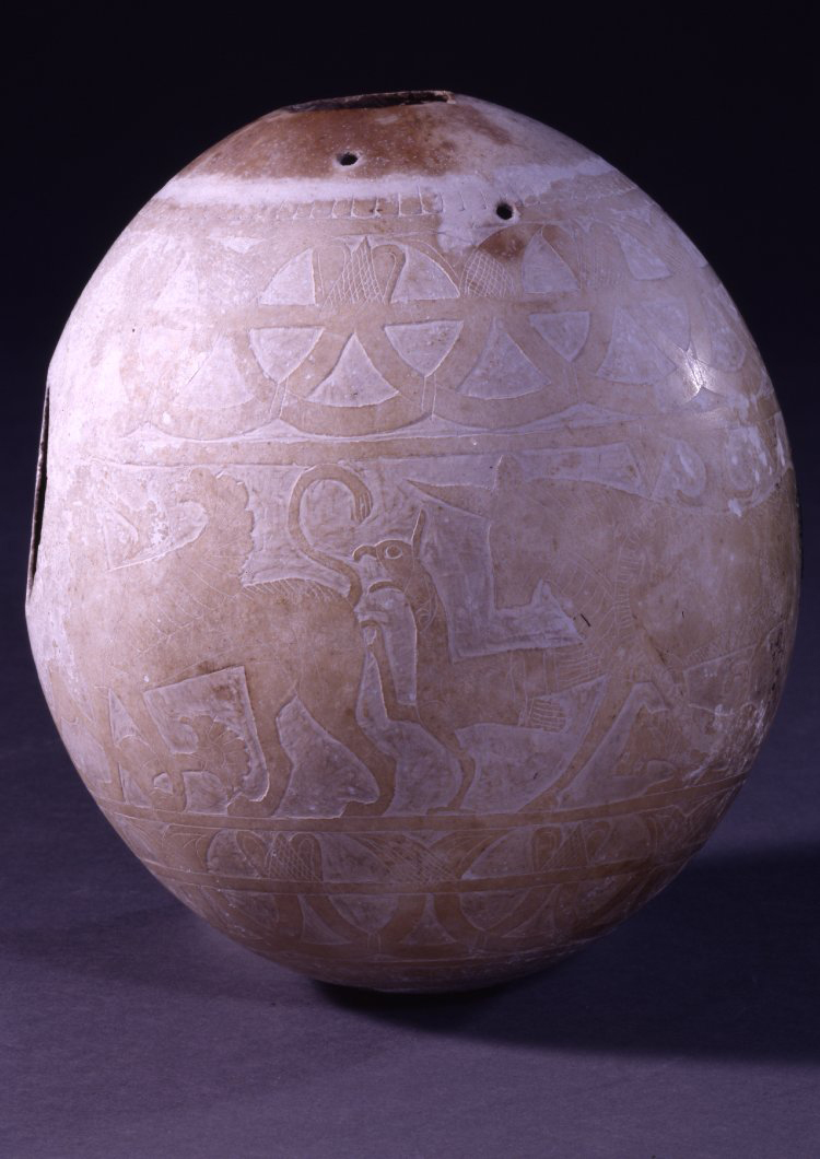 Ostrich egg painted with four sphinxes. It once had a mouthpiece and support to form a vessel. © The Trustees of the British Museum