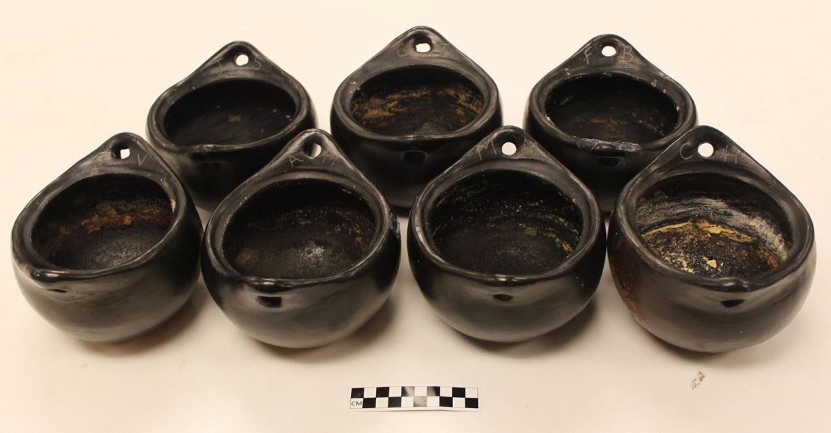 Photo of the la chamba pottery, used over the course of the year-long study, taken at the conclusion of the experiment.
Residues visible on the inner surfaces and pots marked near the handles with the initials of each
archaeologist-chef. Side view. Credit: Jillian Swift