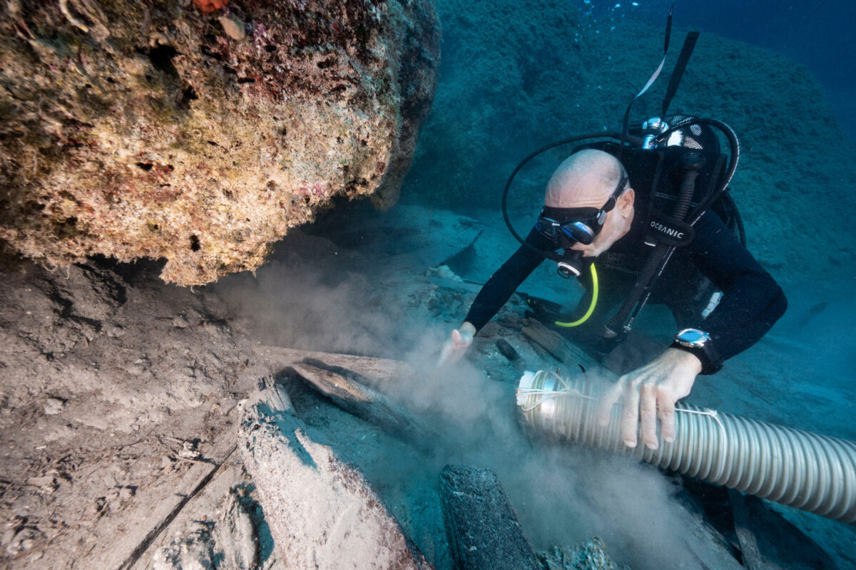Excavating the 2020 Trench site with frames and more of the ship’s timber visible under the rocks. (photo: V. Tsiairis) 