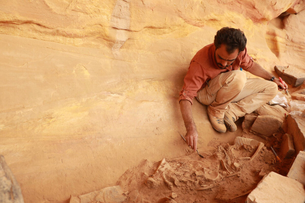 An excavation team director of the Oxford Archaeology landscape survey project excavates a mustatil,
 a type of rectangular structure probably for ritual purposes, that is among the oldest large-scale
stone structures in Arabia (circa 5300-5000 BCE), east of the AlUla Valley. Credit: Royal Commission for AlUla