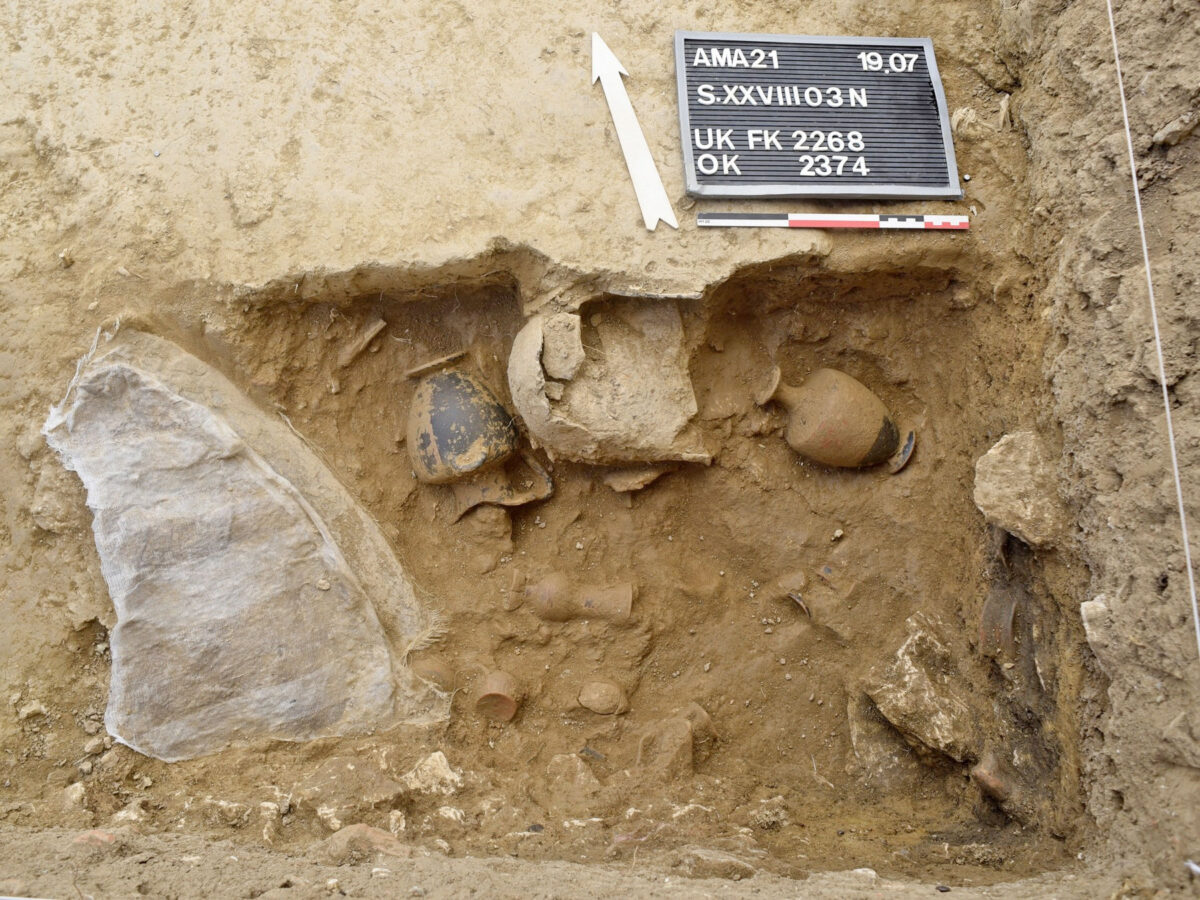 A bronze shield, iron helmet and clay vessels from the foundation deposit of the Late Archaic temple of Artemis Amarysia, Amarynthos (photo: MOCAS) 