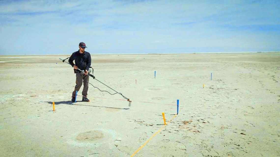 Thomas Urban conducts magnetometer survey of mammoth footprints at White Sands.