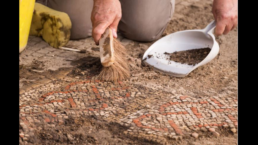 A member of the team from University of Leicester Archaeological Services during the excavations of a large mosaic in Rutland, UK. Credit : Historic England