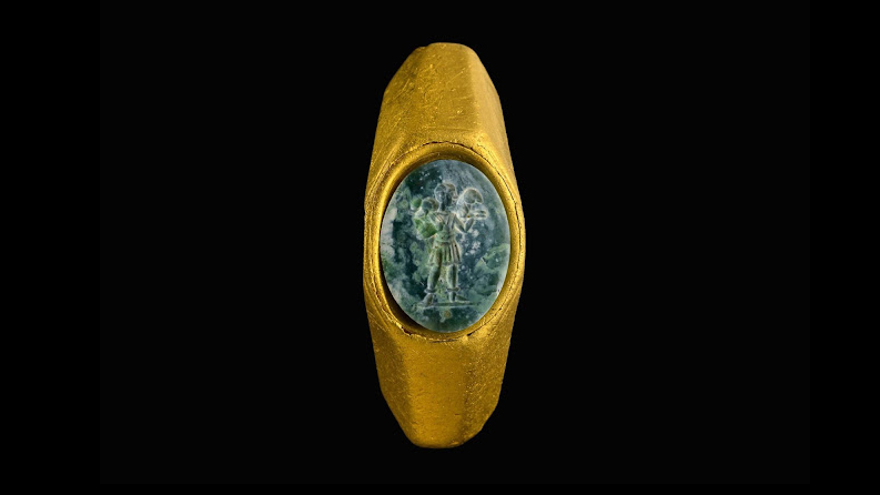 An octagonal gold ring set with a green gemstone and carved with the 'Good Shepherd' figure. Credit: Dafna Gazit, Israel Antiquities Authority