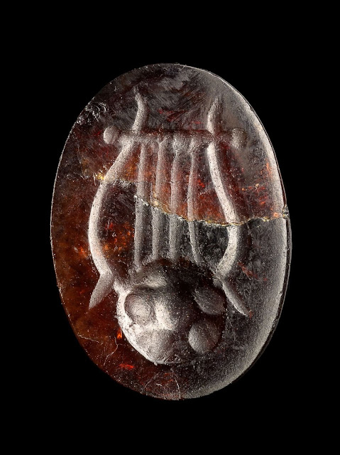 A red gemma engraved with a lyre discovered off the coast of Caesarea. Credit: Yaniv Berman, Israel Antiquities Authority