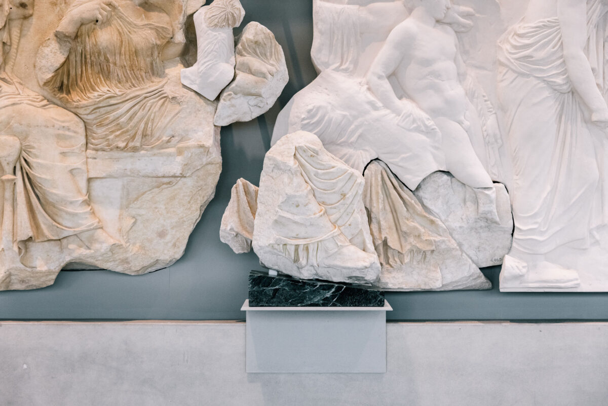 The “Fagan fragment” in front of block VI from the east frieze of the Parthenon. ©Acropolis Museum. Photo: Paris Tavitian