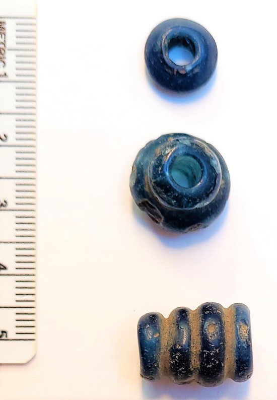 The three blue glass beads of the Frafjord woman are from the early Iron Age and thus several hundred years older than the other beads. Photograph: Museum of Archaeology, University of Stavanger.