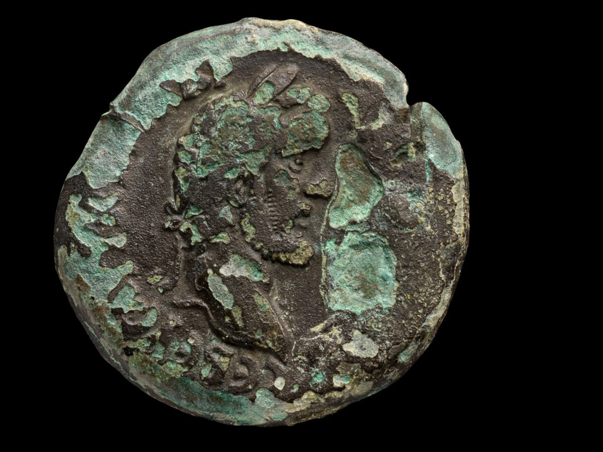 The coin was minted under the emperor Antoninus Pius (138–161 CE) in Alexandria, Egypt. The reverse depicts the zodiac sign Cancer beneath a portrait of the moon goddess Luna. 