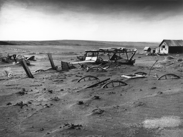 Buried machinery in barn lot in Dallas, South Dakota, United States during the Dust Bowl, an agricultural, ecological, and economic disaster in the Great Plains region of North America in 1936. (image: USDA image no. 00di0971)