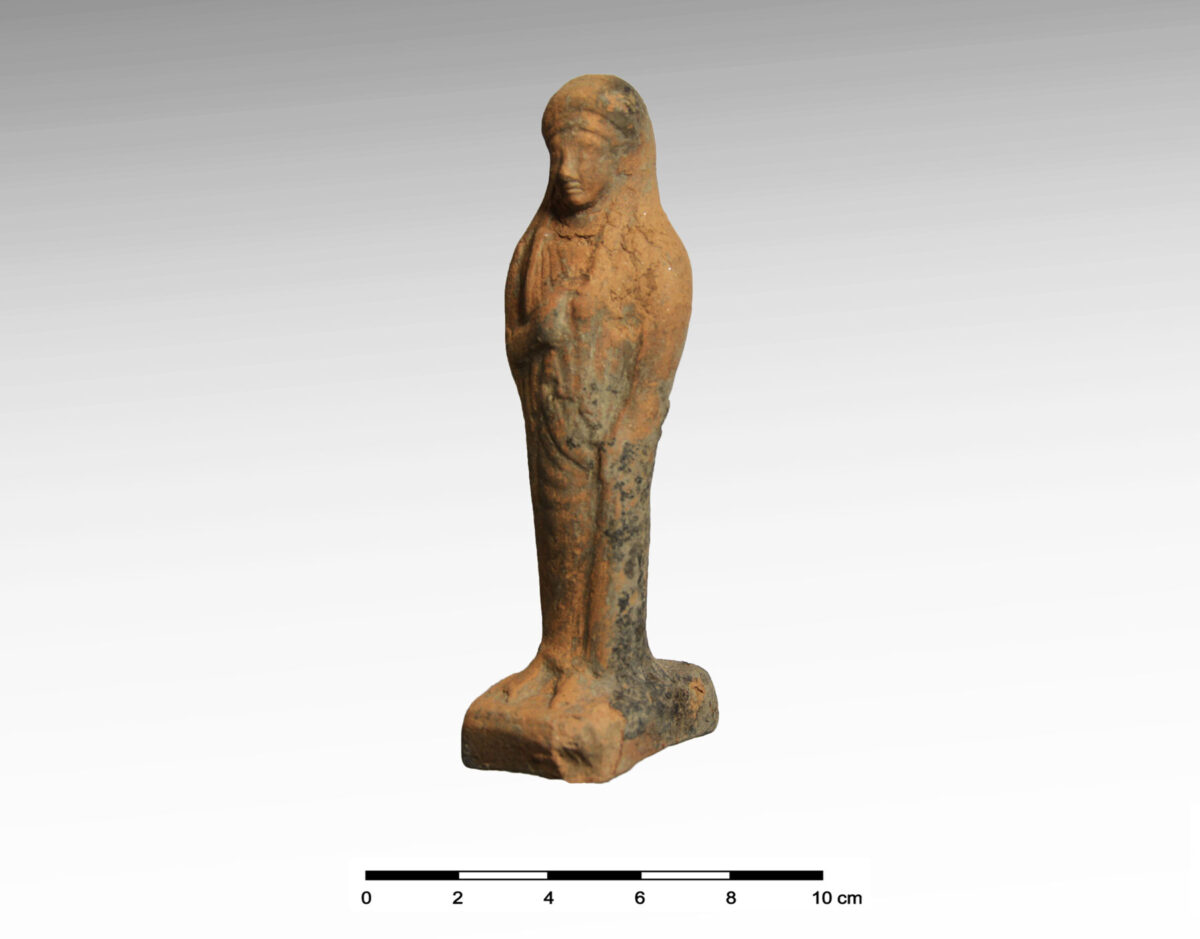 Fig. 14. Clay figurine of a standing female figure of the Archaic period.