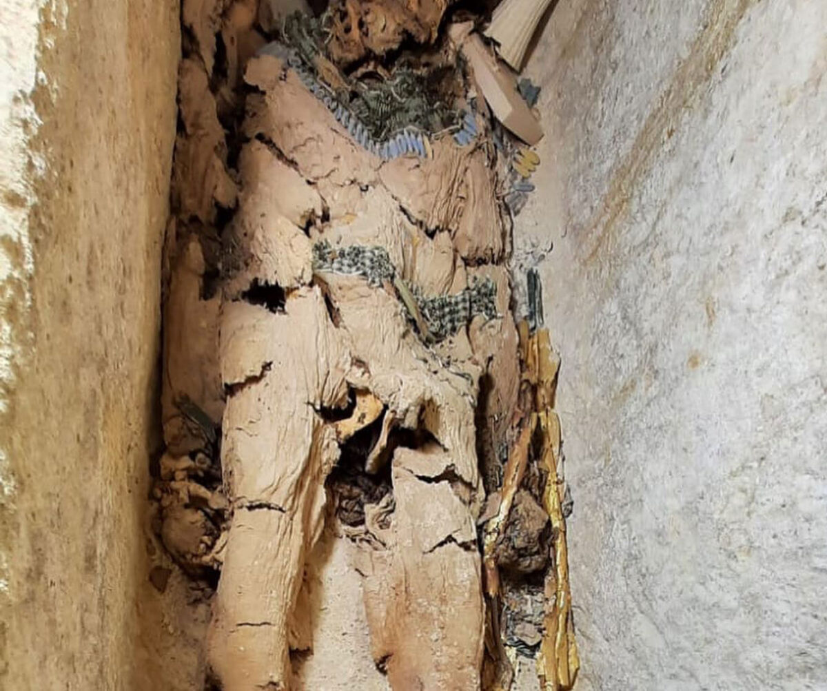 Mummified human remains adorned with gold and semi precious stones. Gisr el Mudir, Saqqara, Jan. 2023. Credit: Zahi Hawass.