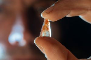 Co-author Ludovic Slimak showing a Neronian nanopoint found in Grotte Mandrin layer E. The studies of these light points show that these tiny points were used as arrowheads 54.000 years ago in Mediterranean France. (Photo Philippe Psaila)