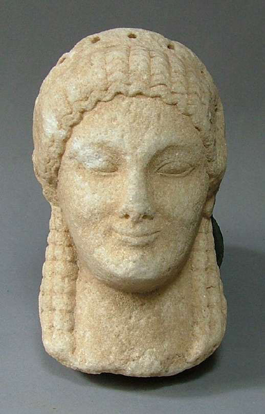Marble head of Kore or Sphinx. Wavy hair locks are framing the forehead, shell-like ones the neck. On the top of the head, diadem deepenings. 550-500 BC. Image source: Ministry of Culture and Sports. 