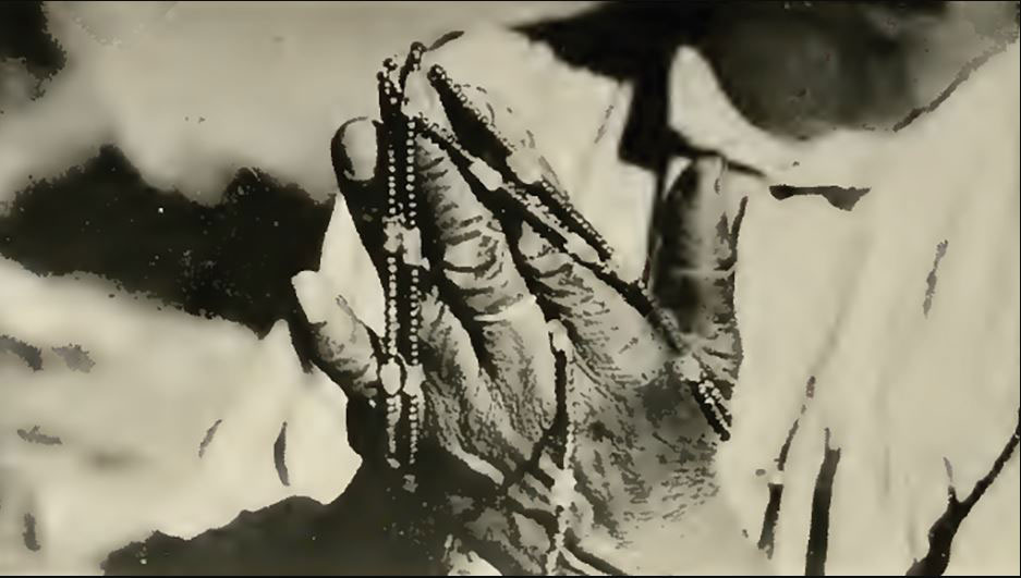 Woman measuring a strand of shell beads in a photo taken in 1918. Photo credit: John P. Harrington / Public Domain.