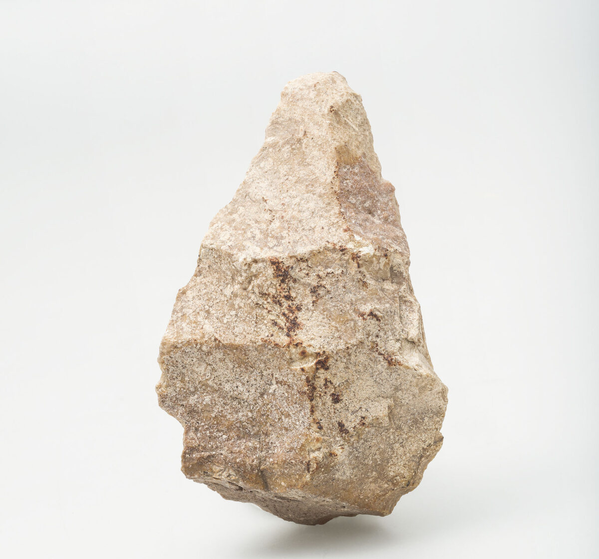 Handaxe on flake, Rodafnidia, Lesbos. Minimum age 300,000– 200,000 years. Sinter. University of Crete excavation. ©Ephorate of Antiquities of Lesbos, Archaeological Museum of Mytilene, accession no. ΠΛΘ58. Photo by Vassilis Tsonis