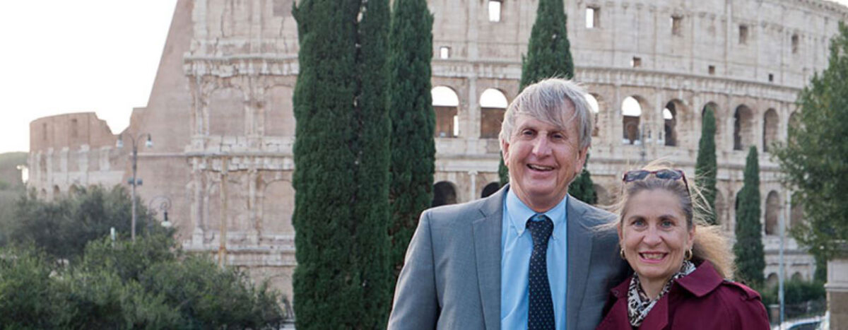 UC Classics Professor Jack Davis and Senior Research Associate Sharon Stocker pose in front of the Colosseum in Rome. Photo/Provided
