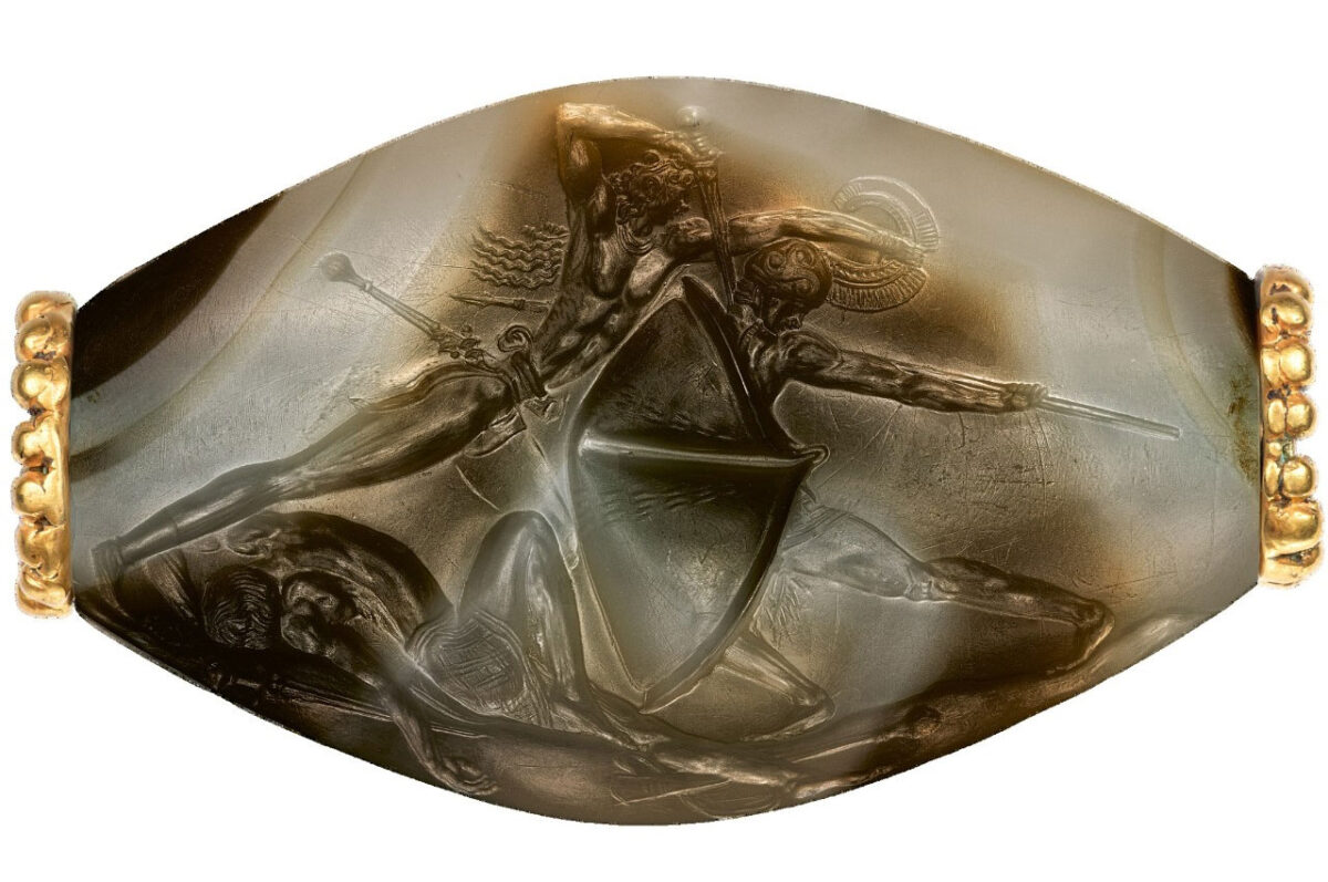Archaeology magazine calls this sealstone from the tomb of the Griffin Warrior a Bronze Age masterpiece. Known as the combat agate, the tiny sealstone depicts mortal combat in exquisite detail. The sealstone will be featured in a new exhibition opening this week at the Getty Villa. Photo/Jeff Vanderpool/UC Classics