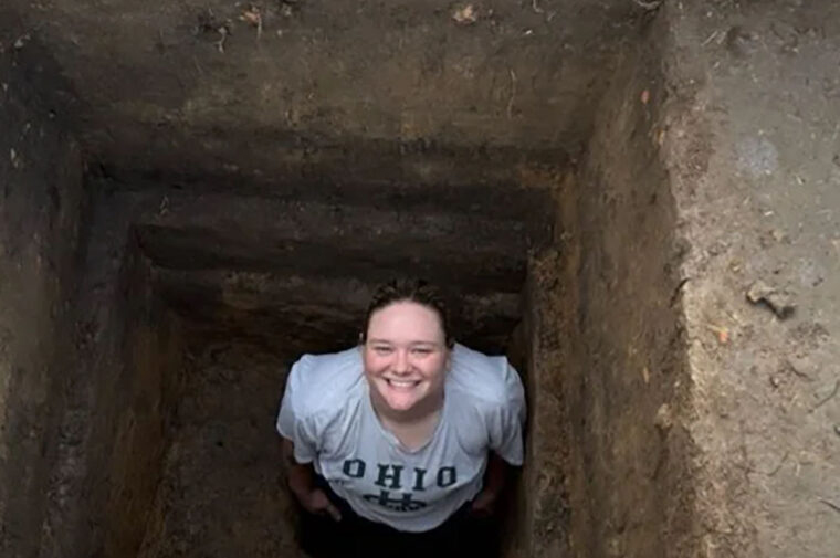 Olivia Baumgartel, a graduate student in archaeology, poses for a photo at a dig site. (Photo courtesy of Kidder and Baumgartel)