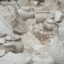 Stone slab with carved human facial features