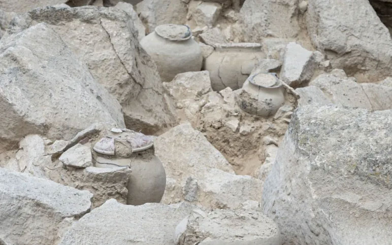 Stone slab with carved human facial features