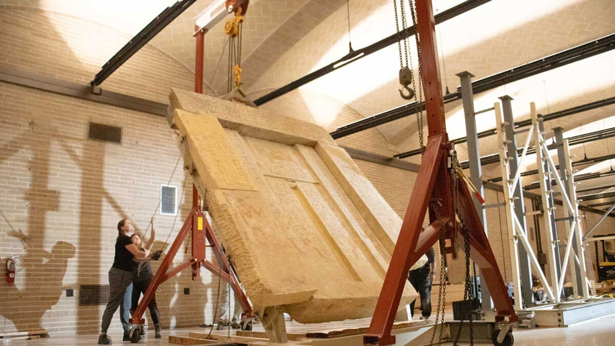 Conservators successfully hoist a 5-ton “false door” to begin the installation of the Tomb Chapel of Kaipure in the Penn Museum’s Main Level galleries. Credit: Kellie Bell for the Penn Museum.